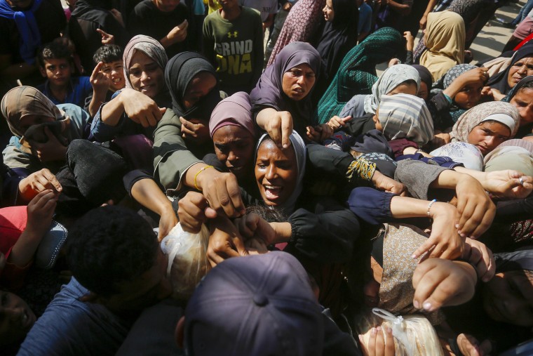 Palestinians in Deir Al Balah struggle to buy bread from the only bakery in the area