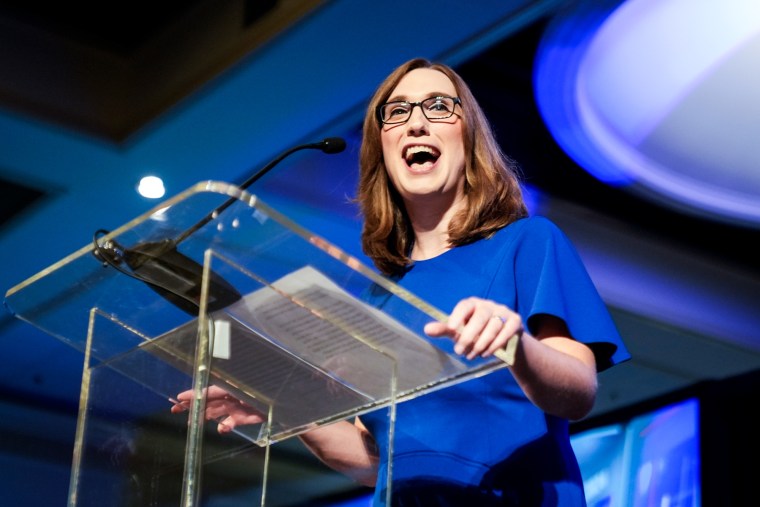 Sarah McBride speaks at a podium on stage