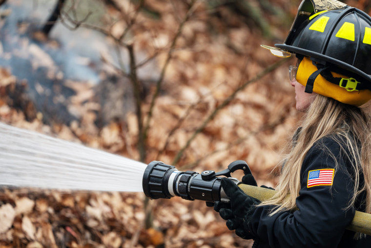 A firefighter battles a wildfire in Greenwood Lake, N.Y., as it approaches a road on Nov. 10.