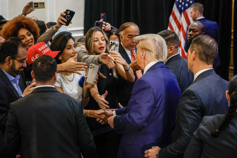 Donald Trump greets people after a roundtable discussion at the Latino Summit.