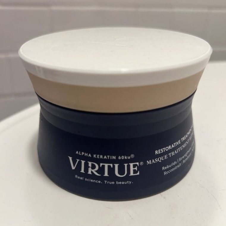 Virtue Restorative, Hydrating Treatment Hair Mask sits on a bathroom counter.