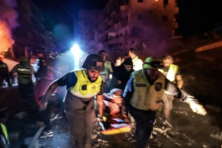 First responders evacuate an injured person following an Israeli airstrike near Tyre, Lebanon, on Oct. 30, 2024.