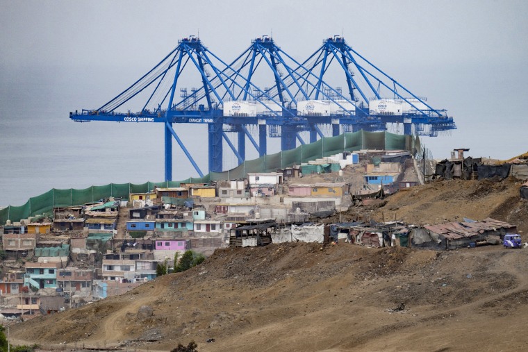 View of the Chancay "megaport" cranes behind a neighborhood in the town of Chancay, 78 kilometers north of the Peruvian capital Lima, on October 29, 2024.