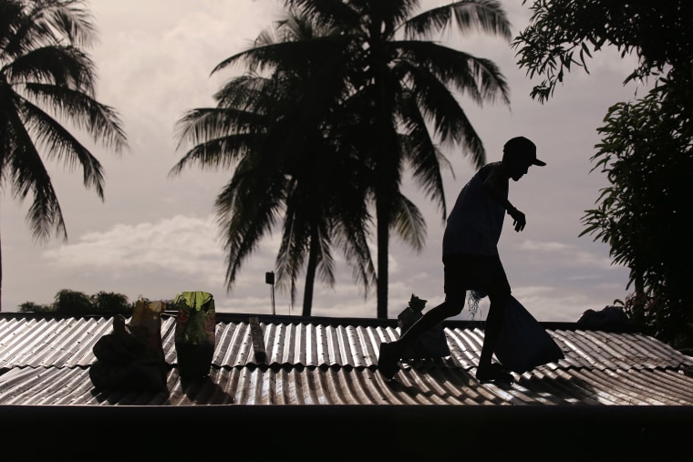 Hundreds of people fled on November 15 as Typhoon Man-Yi bore down on the Philippines, threatening yet more destruction even as rescuers tried to reach people stranded on rooftops by the last tropical cyclone. 