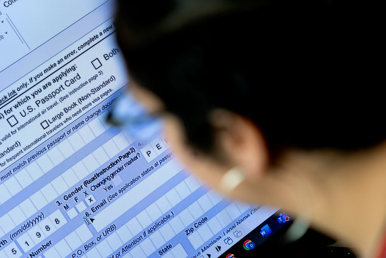 A person fills out a passport application with an X gender marker at their home in Virginia in 2022.