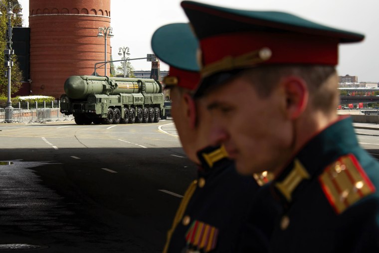 Participants in the victory parade look at the Topol-M (NATO