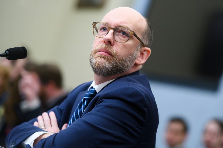 Russell Vought listens during a hearing