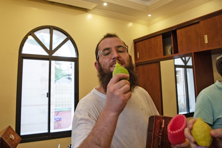 Rabbi Zvi Kogan holds an etrog, a lemon-like citrus fruit, during the celebration of Sukkot on Sept. 20, 2021 in Dubai, United Arab Emirates. 