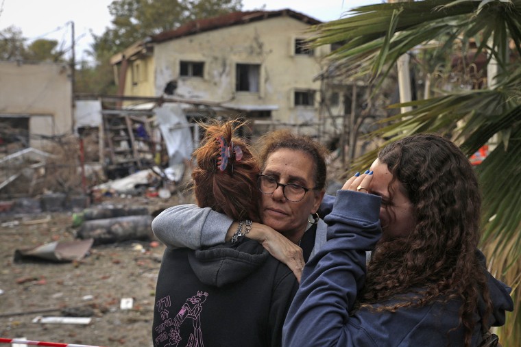 Residents embrace at the site of a rocket attack on Nov. 24, 2024 in Rinatya, Israel. 