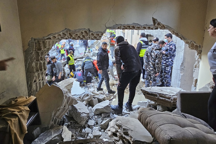 Rescuers and residents search for victims at the site of an Israeli strike that targeted a building in Beirut, Lebanon, Tuesday, Nov. 26, 2024.