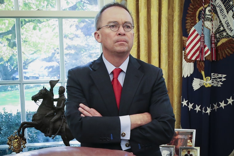 Then acting White House chief of staff Mick Mulvaney listens as President Donald Trump speaks in the Oval Office the White House on Nov. 13, 2019.