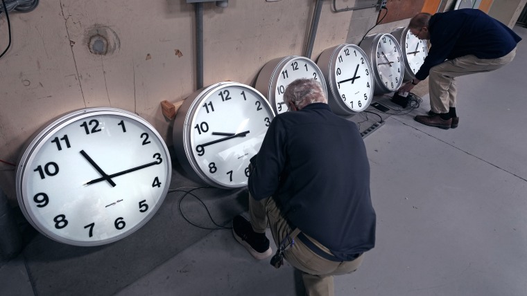 Clocks Rich Finn (on display) and Tom Erb set up the microphones of various clocks installed at Paine Field in Everett, Washington. 