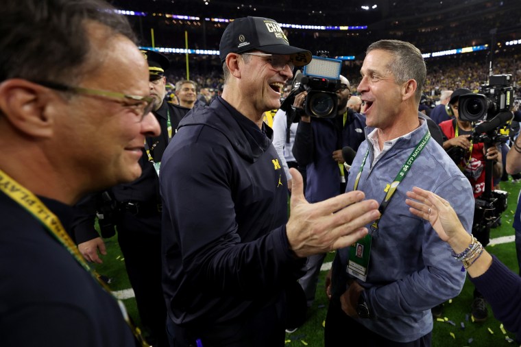 Jim Harbaugh celebrates with his brother, John Harbaugh, after winning the 2024 CFP national championship.