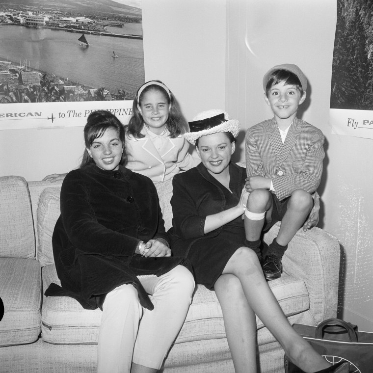 Singer Judy Garland (R) waits with children (left to right) Liza Minnelli, age 16, the daughter of a previous marriage, Lorna Luft, age 9, and Joey Luft, age 7, children of her estranged husband Sid Luft, at New York's Idlewild Airport.