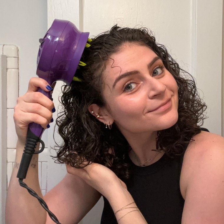 Woman uses the Bed Head diffuser on her curly hair.