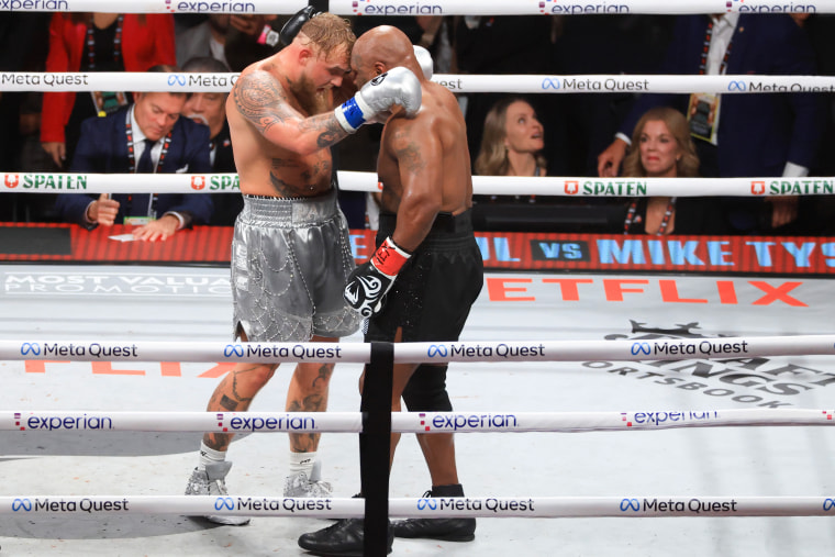 Jake Paul and Mike Tyson hug after their heavyweight bout. 