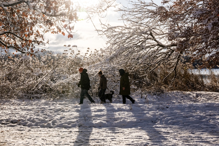 People enjoy a snowy morning in Prospect Park in New York City on December 21, 2024.  