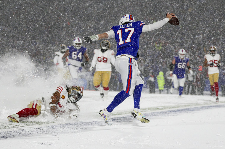 Josh Allen of the Buffalo Bills breaks a tackle by Fred Warner of the San Francisco 49ers as he runs in for a touchdown.