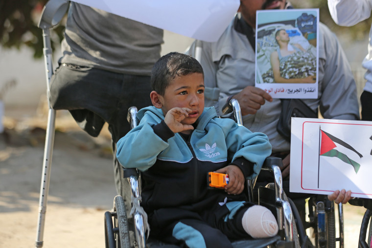 Palestinians injured in Israeli attacks gather near the Al-Ahli Baptist hospital in Gaza City on Dec. 3, 2024, to mark "International Day of Persons with Disabilities."