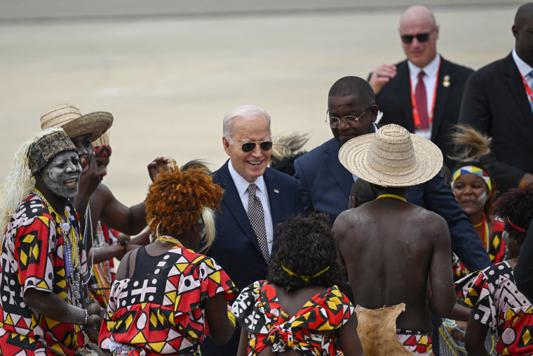 Joe Biden watches a traditional dance at the airport