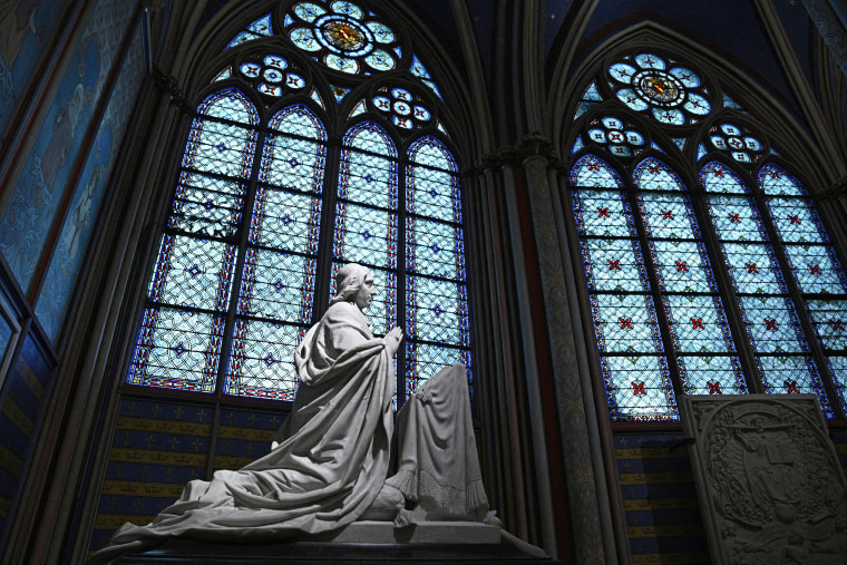 A sculpture of Archbishop Sibour next to stained glass windows at the Notre-Dame de Paris cathedral, in Paris on December 8, 2024.