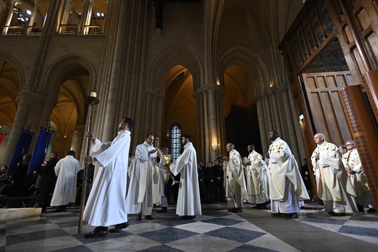 Members of the clergy arrive to attend Mass at the Notre-Dame de Paris cathedral, in Paris on December 8, 2024. 