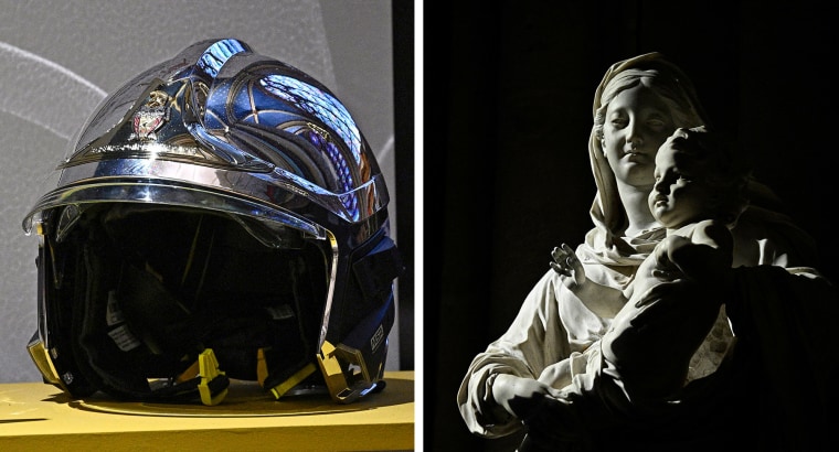 A firefighter helmet on display at the cathedral and a sculpture of the Virgin Mary holding the baby Jesus.