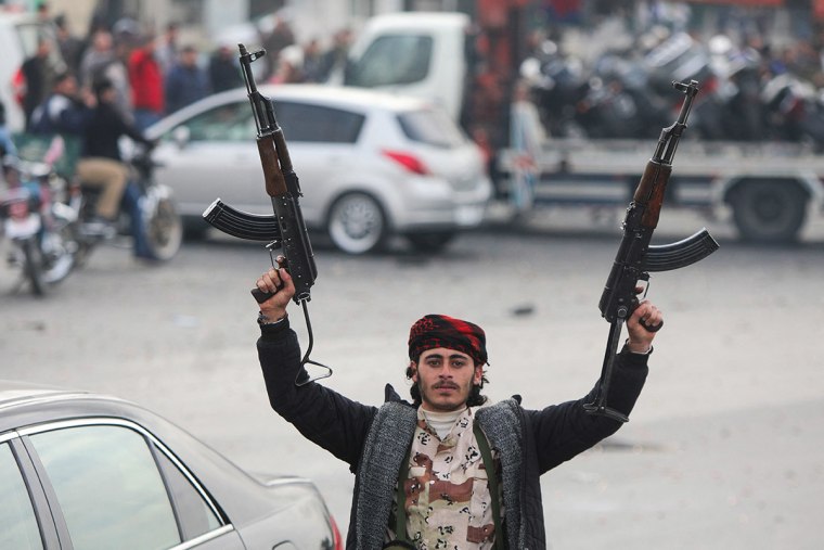 An anti-government fighter celebrates at Umayyad Square in Damascus 