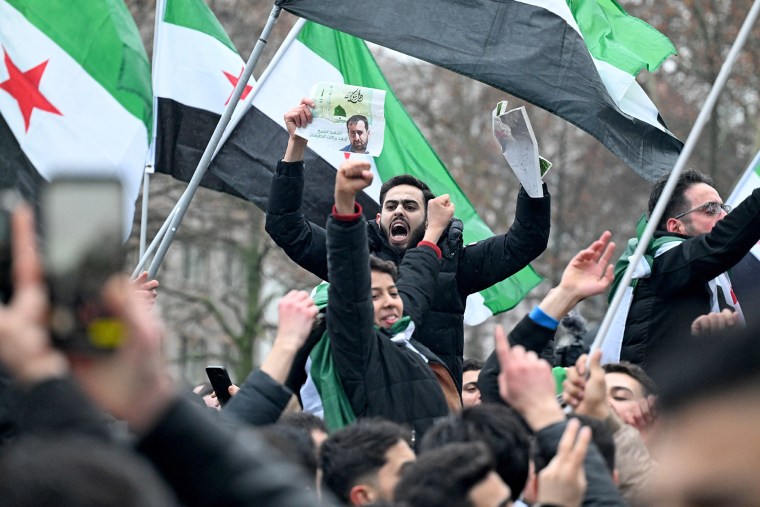 Members of the Syrian community in Berlin celebrate the end of Syrian dictator Bashar al-Assad's rule