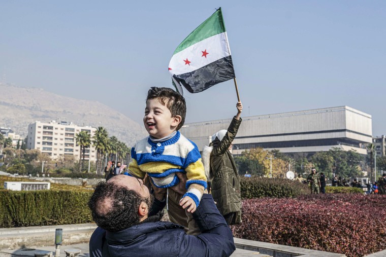 Syrians celebrate the collapse of the Baath Party's 61-year rule