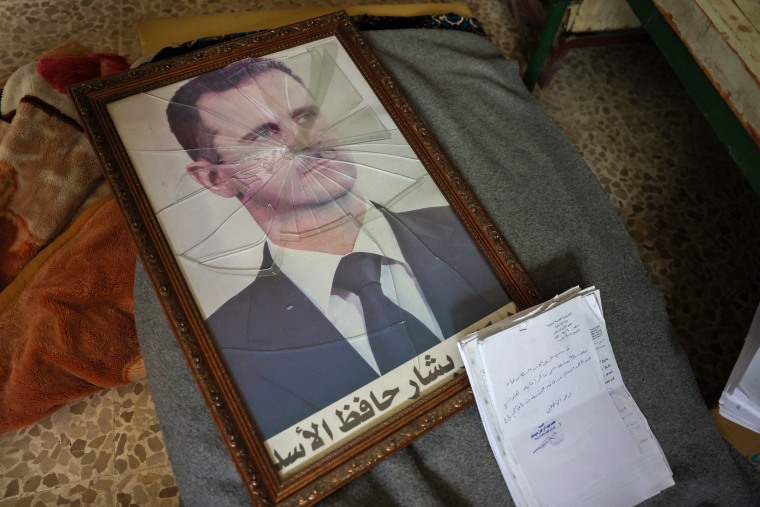 A portrait of Syrian President Bashar al-Assad is destroyed at the Political Security Agency facility on the outskirts of Hama on December 7, 2024. 