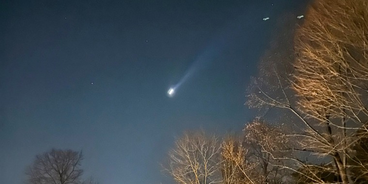 A drone is seen in the night sky