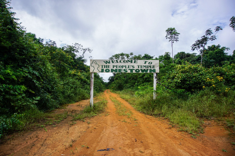 Picture of a welcome sign at the entrance of Jonestown that says "Welcome to the People's Temple Jonestown"