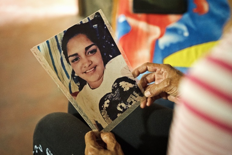 Aurimar Iturriago Villegas's mother looks at her photo at her home in Venezuela.