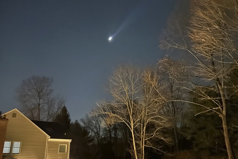 A drone is flying in the night sky 