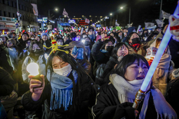 Protesters celebrate the impeachment of South Korean president Yoon Suk Yeol.