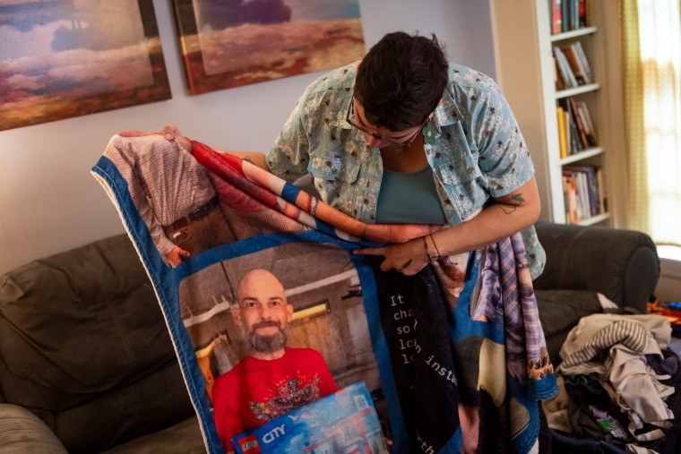 Angela Pike with a blanket commemorating her late husband, Tracy.