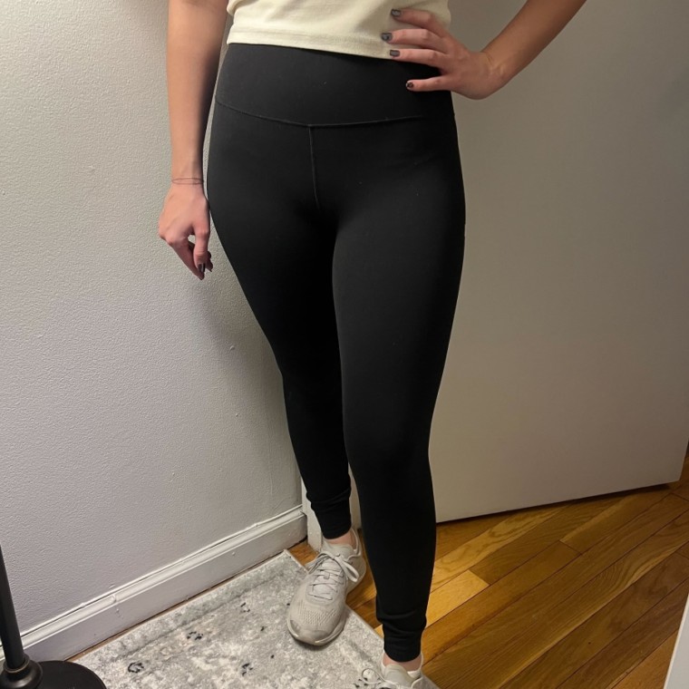 Woman wears a black pair of Vuori AllTheFeels Legging.