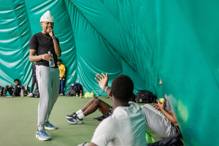 Quincy Wilson jokes with teammates in between activities at track practice in the indoor tennis facility at the Bullis School on December 5, 2024 in Potomac, MD.
