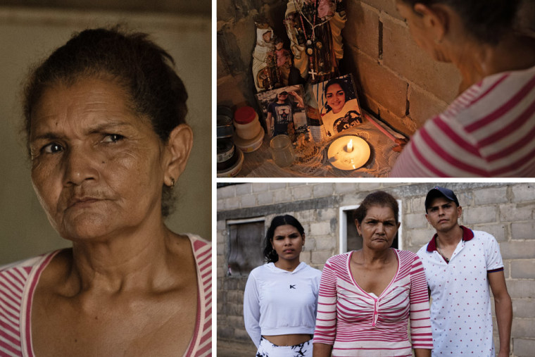 Mourning mother looking at picture of her daughter