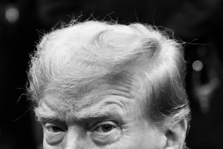 A cropped image of Donald Trump in black and white, just his eyes and hair are shown