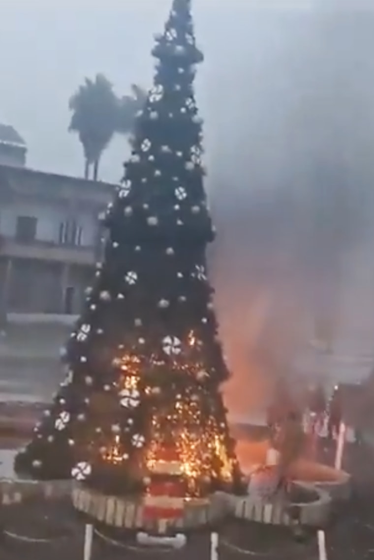 A Christmas tree is set alight in Hama on Monday.