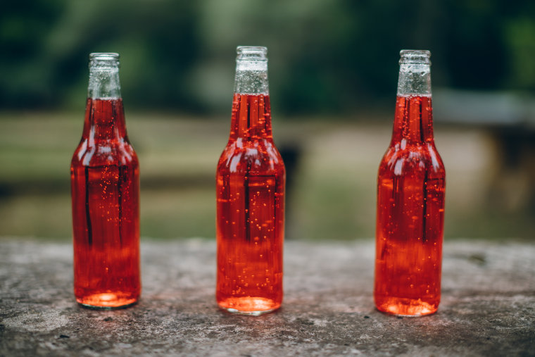 Red soda in three bottles 