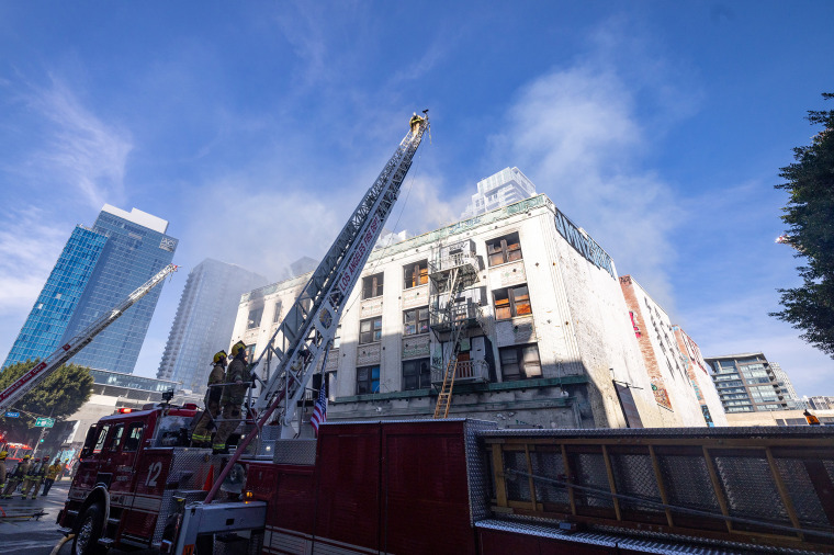 traveling Firefighters mop up after a major alarm fire