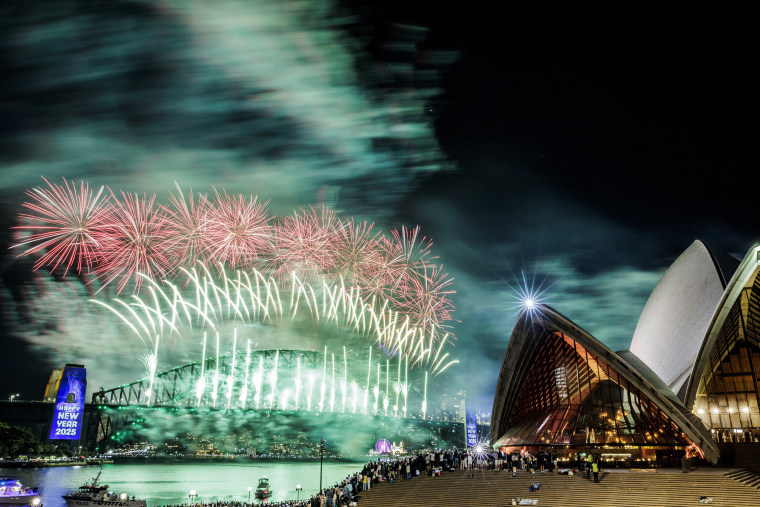 Fireworks light up the sky behind the Sydney Opera House on January 1, 2025.