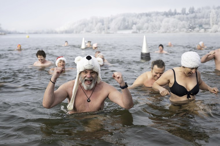 Swimmers take a dip in Lake Moossee in Moosseedorf, Switzerland, a New Year's Eve tradition.