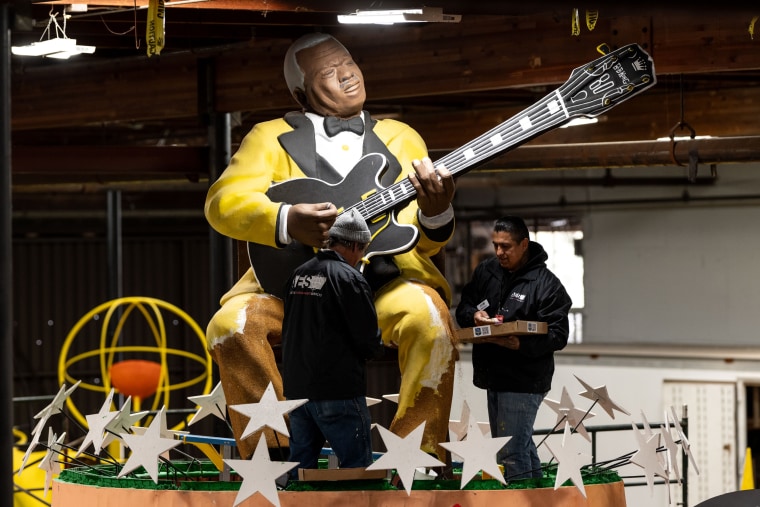 Volunteers prepare floats for the 136th annual Rose Parade