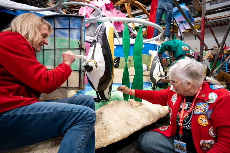 Volunteers prepare floats for the 136th annual Rose Parade