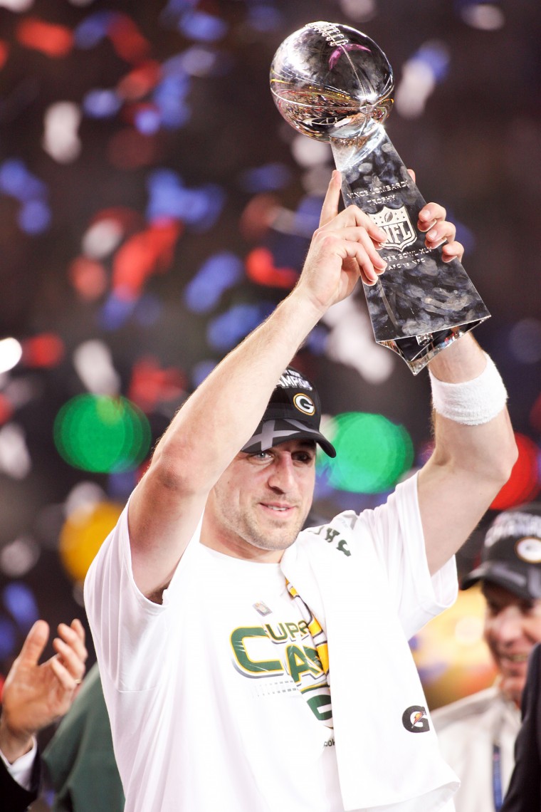 Aaron Rodgers #12 of the Green Bay Packers holds the Vince Lombardi Trophy after defeating the Pittsburgh Steelers during Super Bowl XLV.