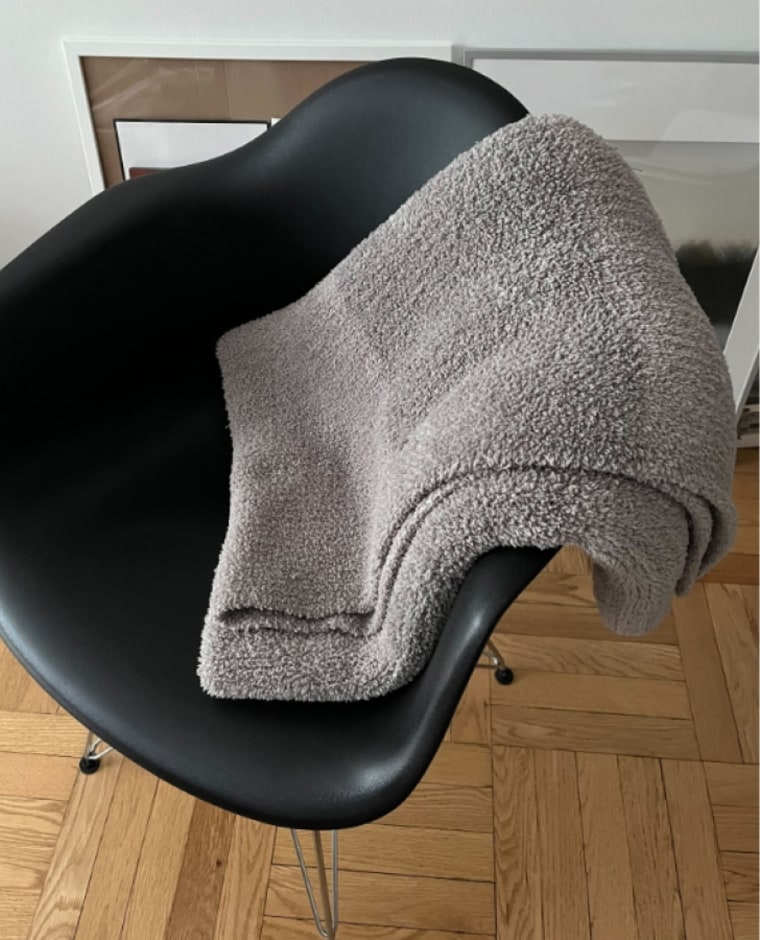 Ginsberg owns two of the Barefoot Dreams CozyChic throw blankets, and says that her cats love using them too. 